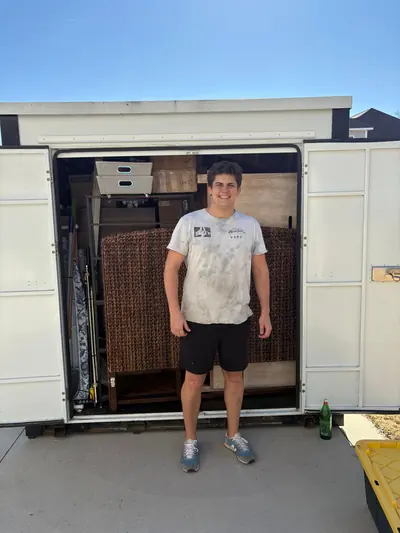 A mover standing in front of a loaded portable storage container